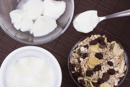 Yogurt with muesli on a wooden mat.の写真素材
