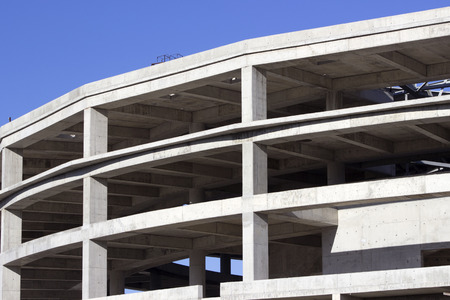 Construction of a sports hall against blue sky.