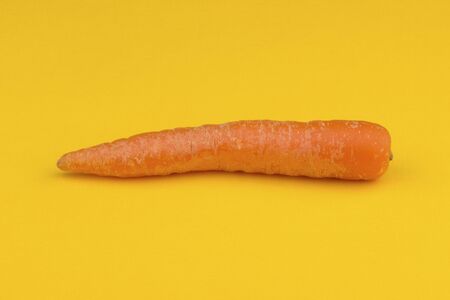 Carrot on yellow tablecloth.の写真素材