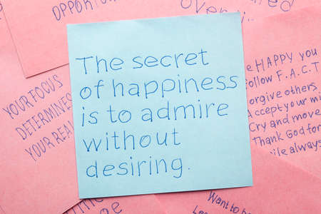 The secret of happiness written on note.