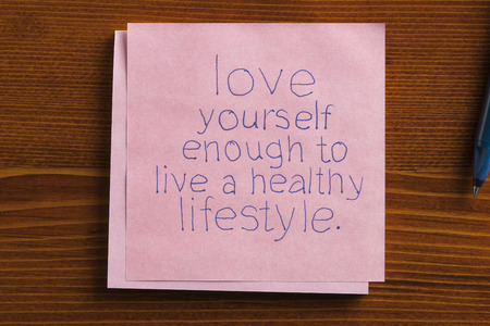 Top view of Love yourself enough to live a healthy lifestyle written note.の写真素材