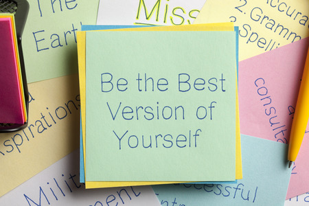 Top view of Be the Best Version of Yourself written on a note with a pen aside.の写真素材