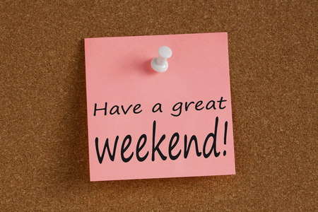 Have a great weekend written on remember note with pin on cork board.の写真素材
