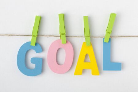 GOAL written in alphabet letters with wooden pinch on white background. Business Concept.の写真素材