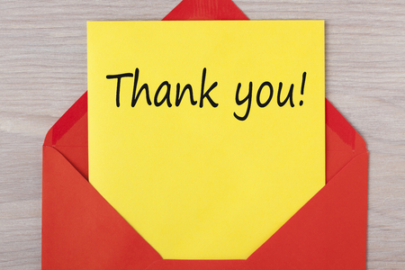 Thank you! written on letter in red envelope. Business concept.の写真素材