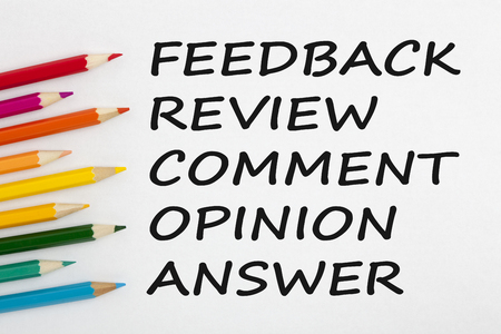 Feedback, review, comment, opinion or answer written on a white background and colour pencils. Business concept words.Top view.の写真素材