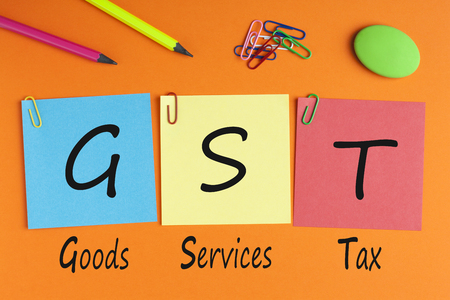 Goods Services Tax words with GST written on color notes with and office supplies. Business Concept. Top view.の写真素材