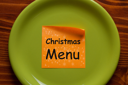 Christmas Menu written on sticky note on the green plate.の写真素材