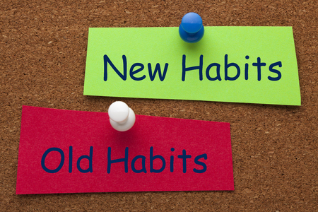 New Habits vs Old Habits words on colorful stickers pinned on cork board. Business concept.の写真素材