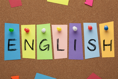 English word written in colorful stickers pinned on cork board. Learning languages conceptの写真素材