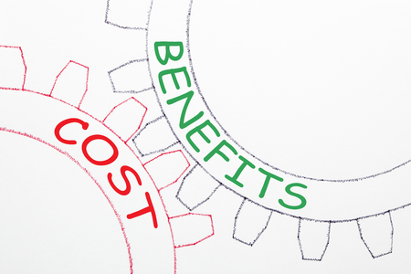 COSTS and BENEFITS text on the mechanism of gears. Business concept.の写真素材