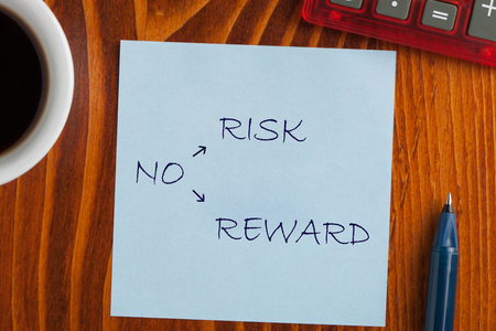 No Risk No Reward on note with pen a side, cup of coffee and calculator. Business conceptの写真素材