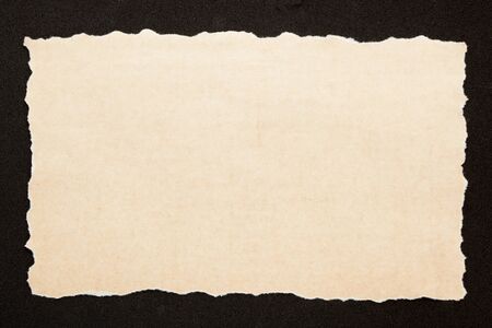 Old paper with empty place for your text on black background. Reminder concept
