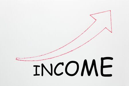 Word Income under ascending arrow on white background. Business Concept.の写真素材