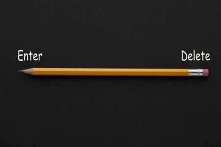 The words enter, delete with pencil on black background. Business concept.