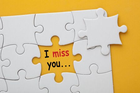 Missing jigsaw puzzle piece with text I miss you の写真素材