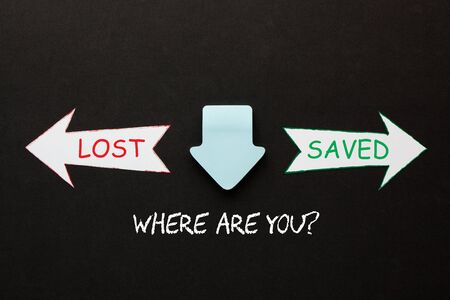Where are you question saved or lost in paper arrows on black background. Are you sure you are a christian? の写真素材