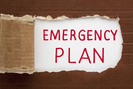 Emergency plan text under torn paper. Business conceptの写真素材