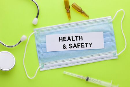 Health and Safety text on white sticker with stethoscope, syringe and ampoule. Medical concept.の写真素材