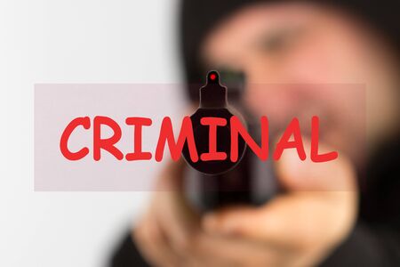 The word criminal over man with gun backgroundの写真素材