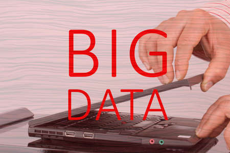 Male hands open laptop with text big dataの写真素材