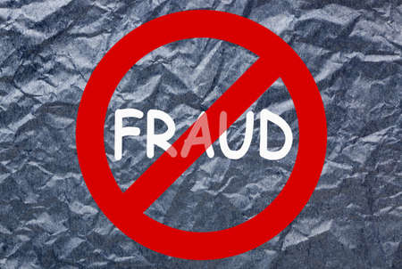 Stop fraud sign on crumpled paper.
