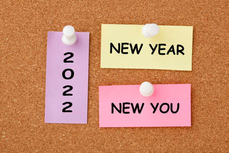 New year, new you text on colorful notes pinned on cork board.の写真素材