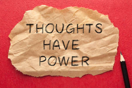 Thoughts have power text on wrinkled lined paper with pencil.の写真素材