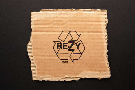 Resy Recycling symbol on a piece of torn paper.の写真素材