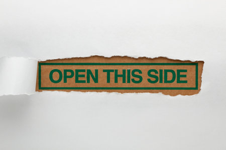 Craft paper hole with text Open This Sideの写真素材