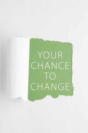 Torn hole in sheet of paper on green background with text Your Chance To Change. Inspiring creative motivation quote template.の写真素材