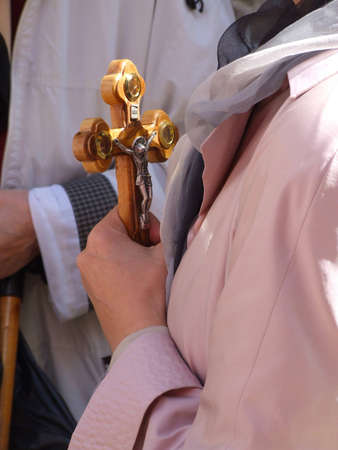 Woman holding a cross for different usesの写真素材