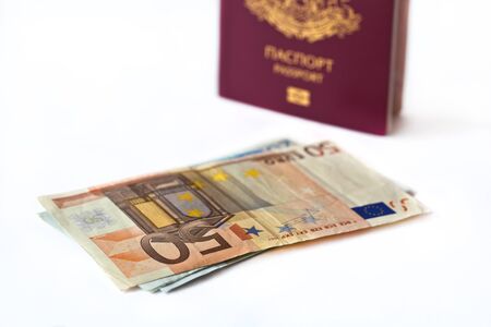 Passport  and several banknotes on white background.の写真素材