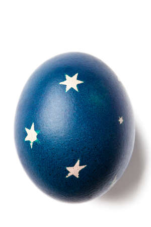 Blue painted Easter egg with decorations isolated on white.の写真素材