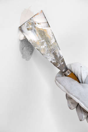 Worker is plastering a wall by spatula and plasterの写真素材