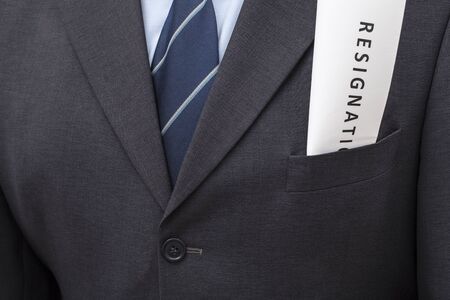 Folded letter of resignation, put in a jacket's pocket of a man.