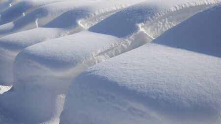 Many parked cars under deep snow cover after snow blizzard.