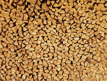 Cut and stacked a lot of firewood pieces as background.