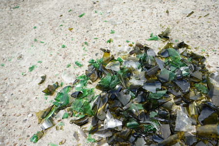 Fragments of colored broken glass on a concrete surfaceの写真素材