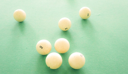 Big white billiard balls on green clothの写真素材