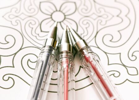 Multicolored gel pens  on Adult coloring book