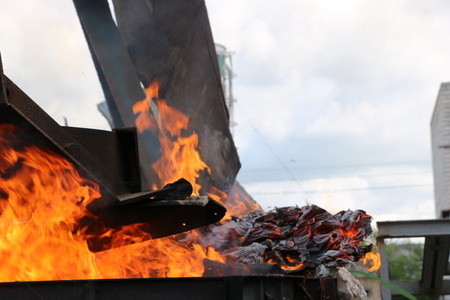 Iron metal structures covered with a bright flame of fire from containers