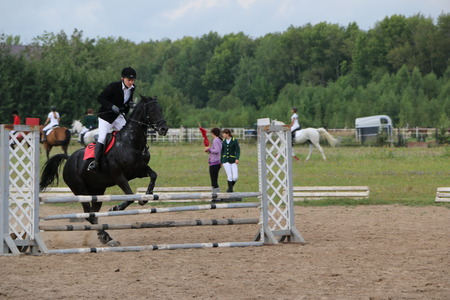 Medvedev, RUSSIA, AUGUST 26, 2017: Open championship on horse racing and jumping devoted to the day of the settlement of Medvedev - show-jumping- jumping over an obstacleのeditorial素材