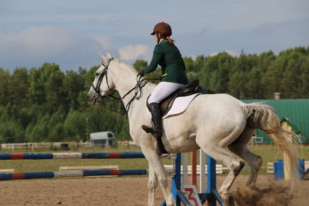 Medvedev, RUSSIA, AUGUST 26, 2017: Open championship on horse racing and jumping devoted to the day of the settlement of Medvedev - show-jumping- jumping over an obstacleのeditorial素材