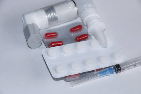 Set of medications - Pills, syringe, inhaler, thermometer, spray on white background