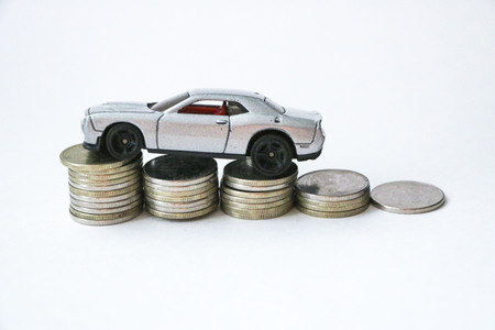 silver car on coins. rise or fall of sales. car loan.の写真素材