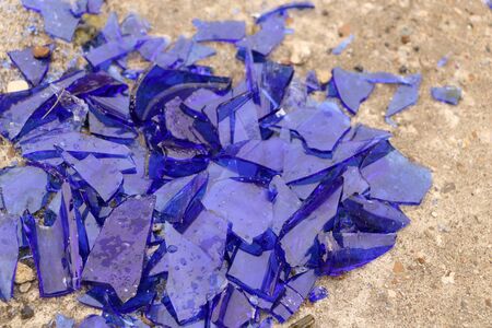 blue broken glass on a concrete surface - texture for a background, design