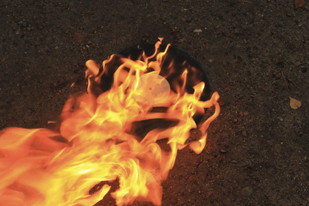 The old vinyl black plate is embraced by a bright strong flameの写真素材