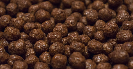 Chocolate cereal flakes in the form of balls on a dark background