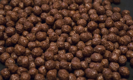 Chocolate cereal flakes in the form of balls on a dark background